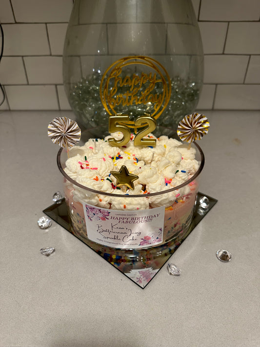 Extra large custom birthday cake candle with 'Happy Birthday' and decorative toppers on a countertop.