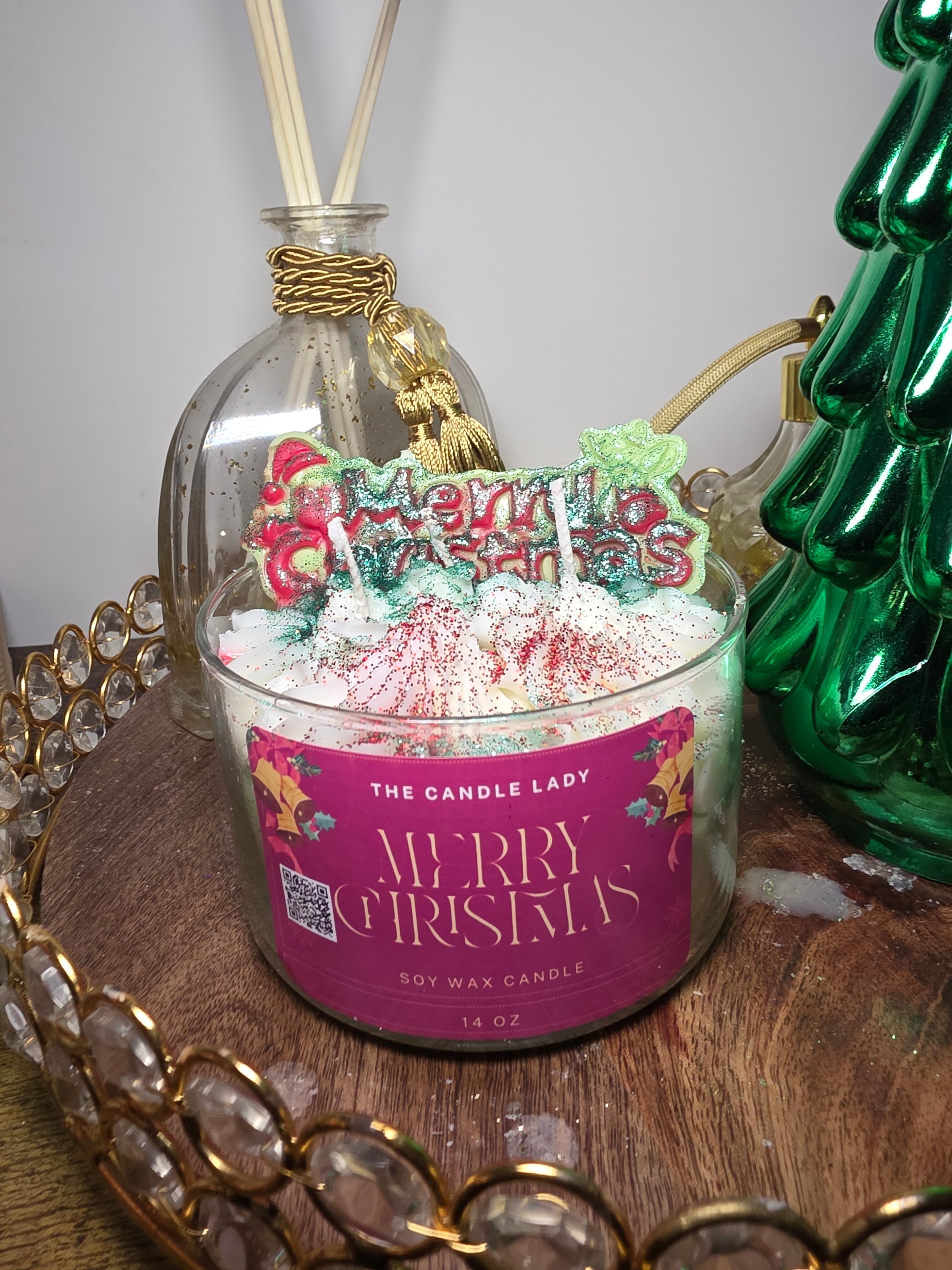 Decorative candle with a festive label on a decorative stand.