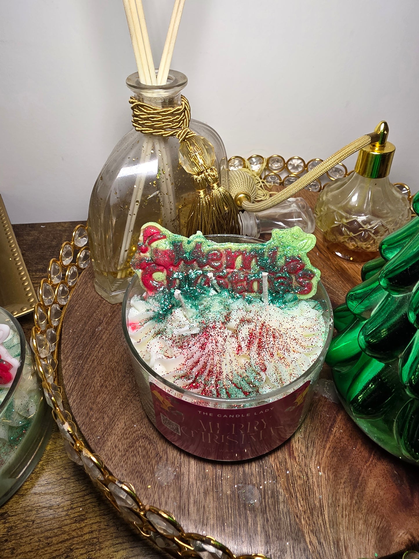 Decorative bottle with a Christmas-themed stopper on a wooden surface