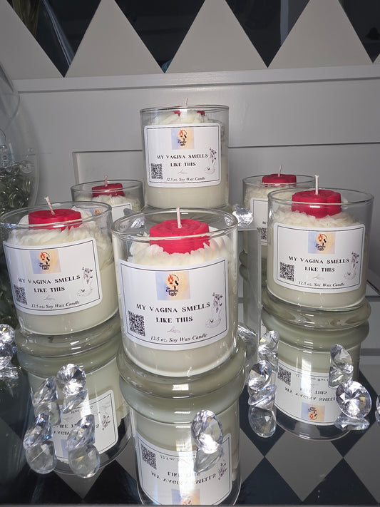 Stack of glass candles with labels on a checkered floor