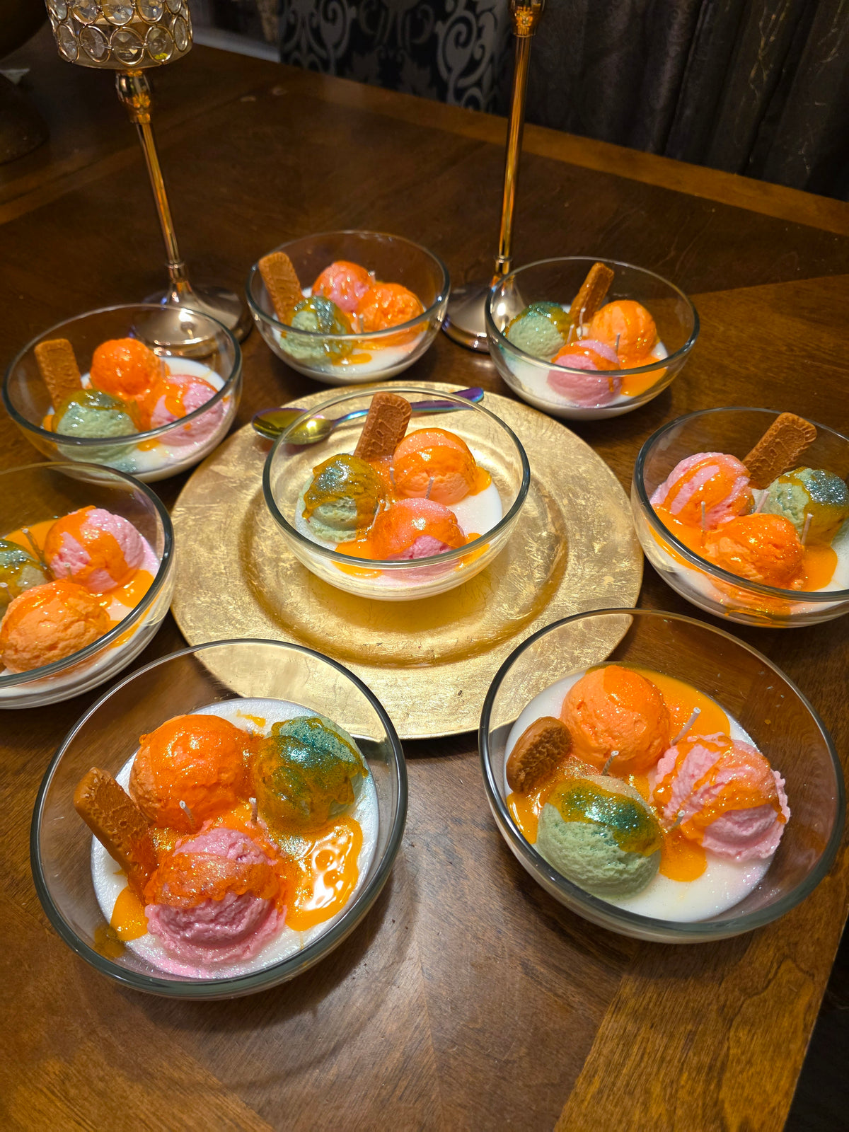 Dessert bowls with colorful sherbert and cookies on a wooden table